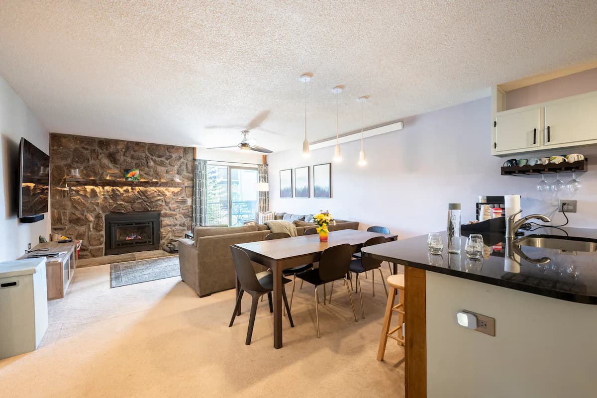 Open kitchen with counter seating beside the dining and living area